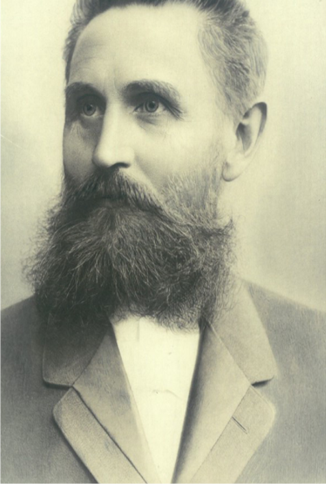 Eine schwarz-weiß Aufnahme des Stiftungsgründers der Hans-Wendt-Stiftung, Hermnn Otto Wendt - mit dichtem Bart, weißem Hemd und dunklem Jacket.